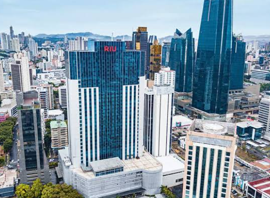 An aerial perspective highlighting the sheer scale and strategic urban integration of the Hotel Riu Plaza Panama.